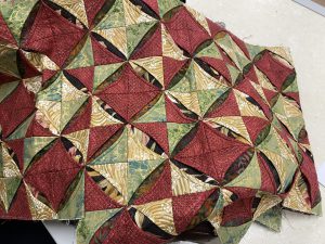 Judith started 10 years ago cathedral windows table runner